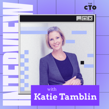 CTO interview with Kate Tamblin: A professional woman in a business suit sitting across from an interviewer, engaged in a conversation. IT Optimization featured image