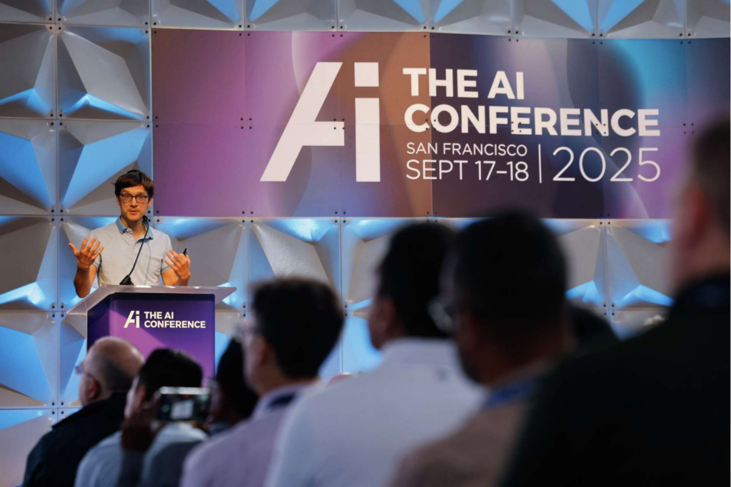 Speaker presenting on stage at The AI Conference 2025 before a live audience