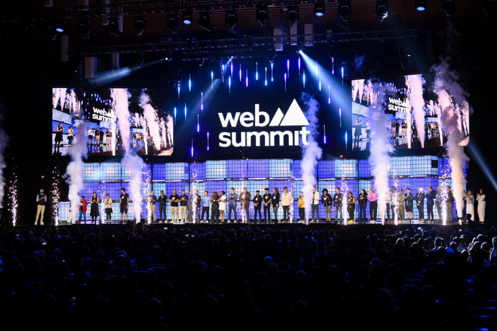 Web Summit opening stage with speakers and a packed audience
