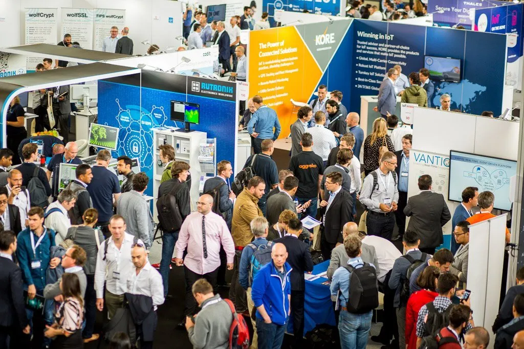 Crowded exhibition floor of Cyber Security & Cloud Expo Europe with attendees visiting technology vendor booths