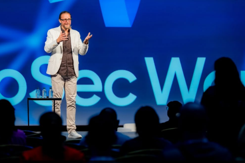 InfoSec World 2025 keynote speaker presenting to a cybersecurity audience