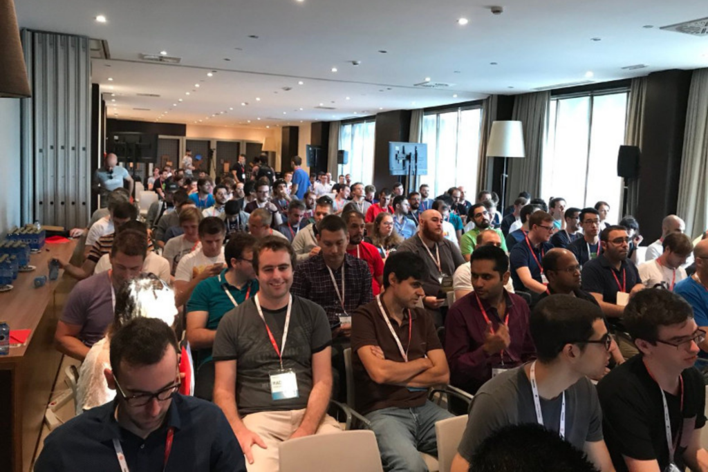 Attendees gathered for a developer-focused technology event session at the React Alicante session