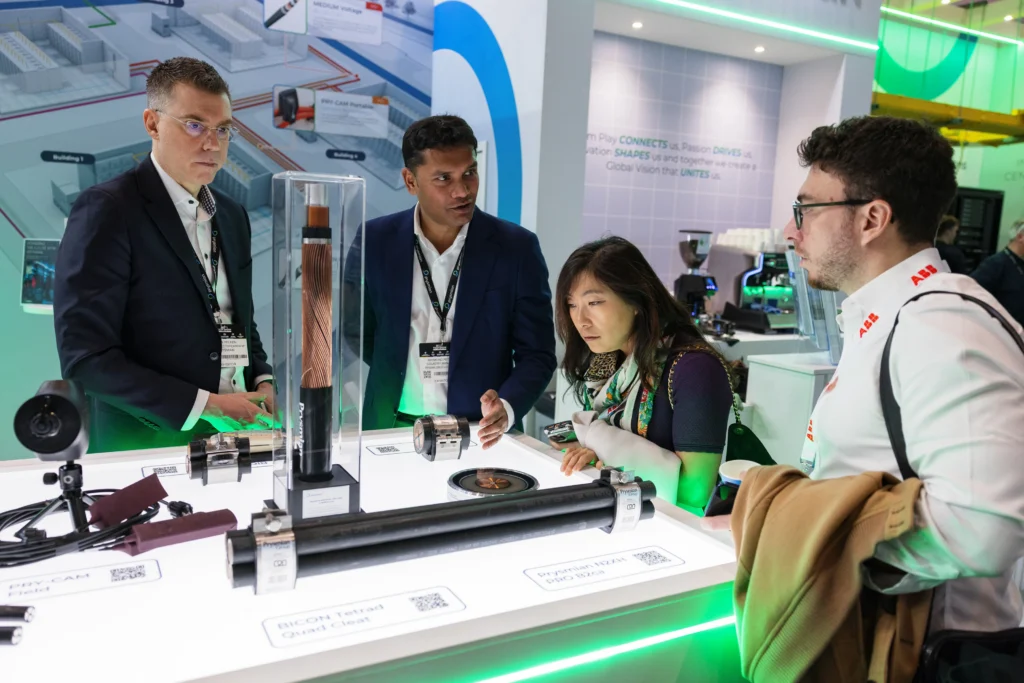 Visitors discussing data center equipment and technology displays at an exhibitor booth during Data Centre World.