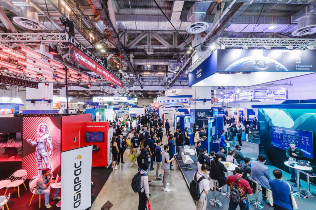 Crowded exhibition hall of GovWare conference with vendor booths and attendees networking