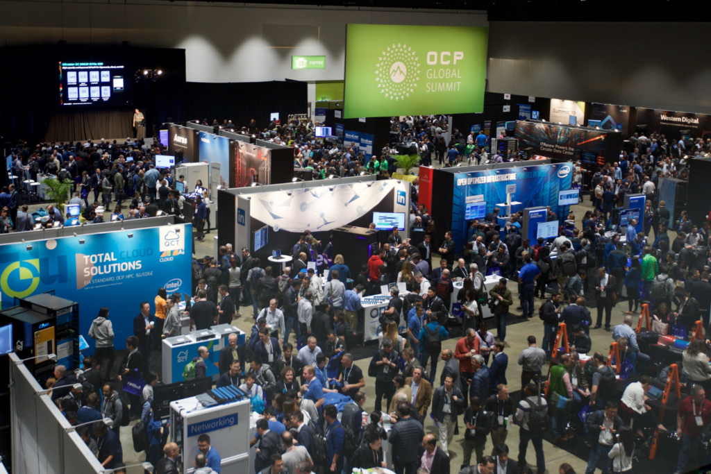 Crowded OCP Global Summit expo floor with infrastructure technology booths