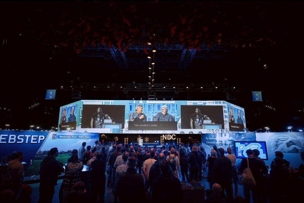Attendees watching a live presentation on the main stage at NDC Oslo