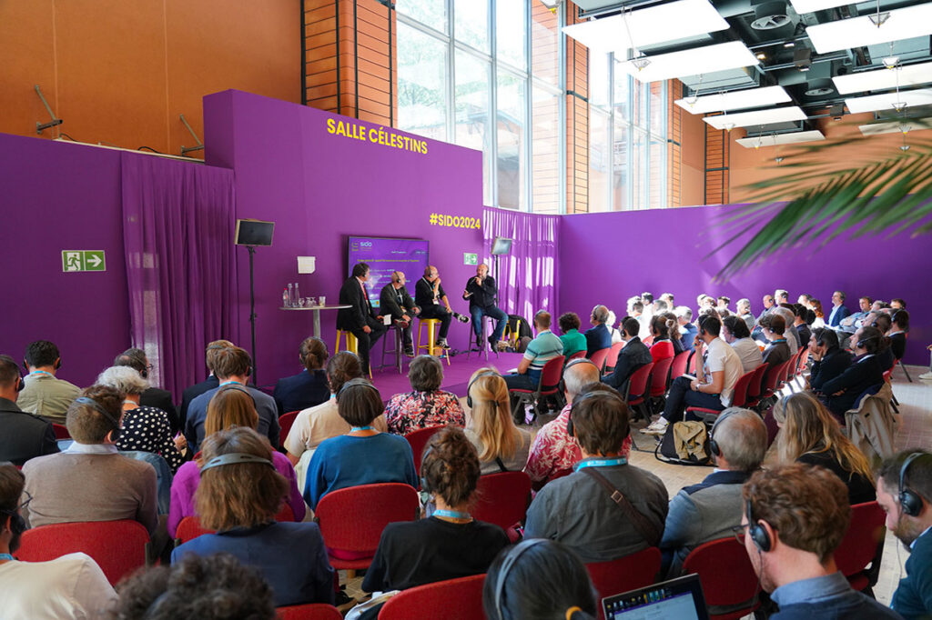 A packed audience for a panel discussion at the SIDO conference