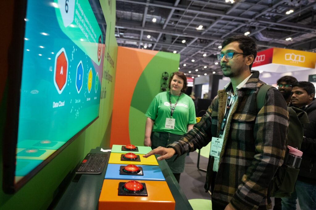 An attendee interacts with an AI-powered touchscreen demo at Big Data &amp; AI World London