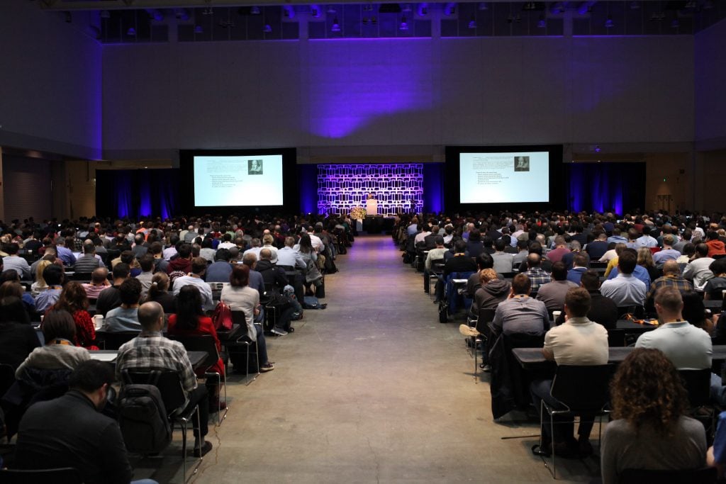 A large audience attends a keynote presentation at the ODSC AI