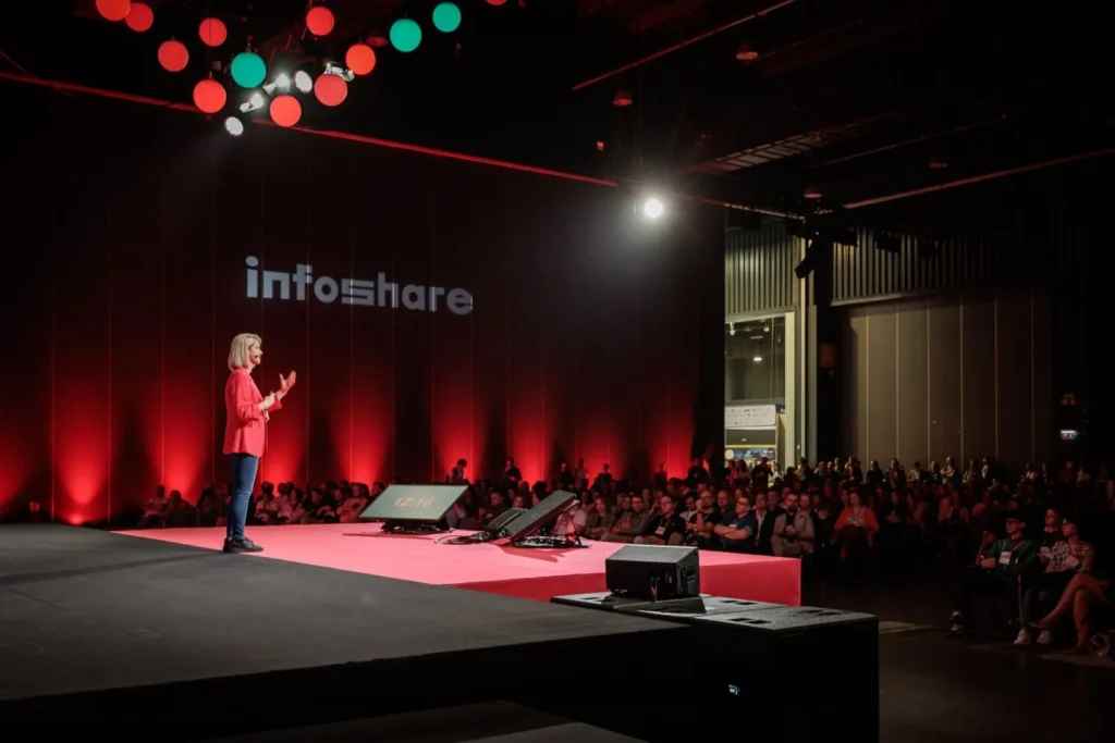 Speaker sharing industry insights on stage at the Infoshare Conference