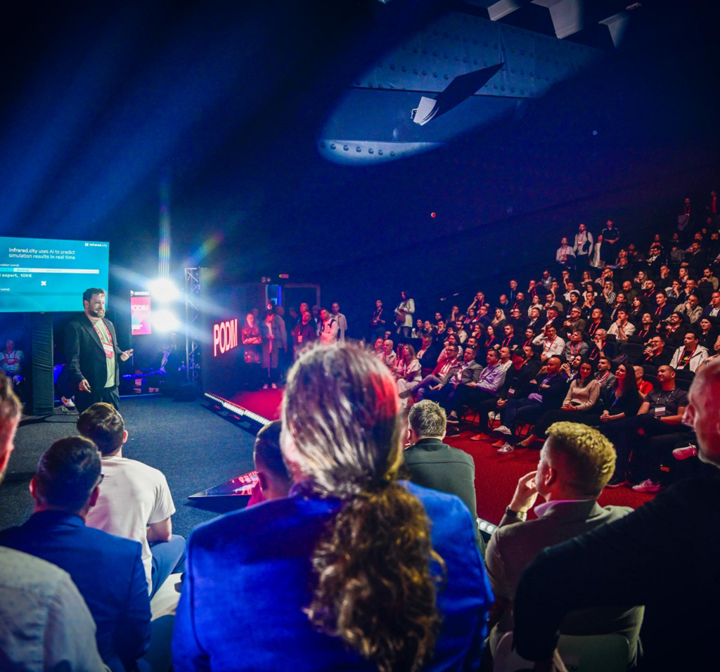 A focused audience listening to an inspiring talk at the Podim