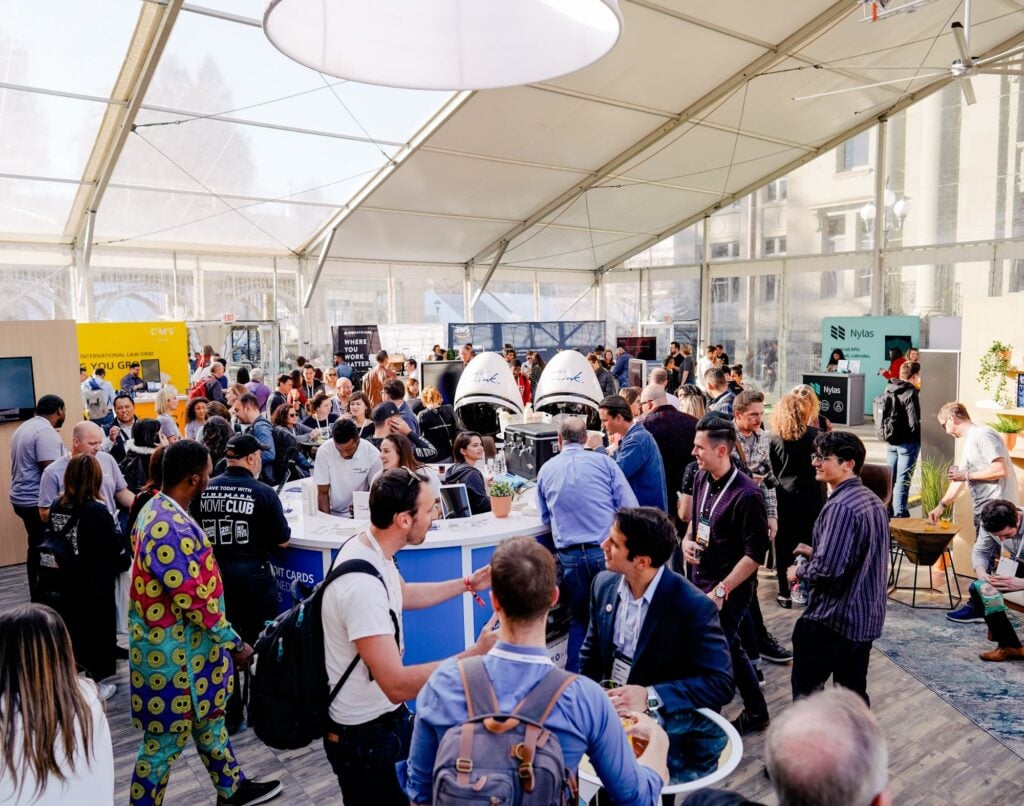 Attendees exploring and networking at the trade show floor of the Startup Grind